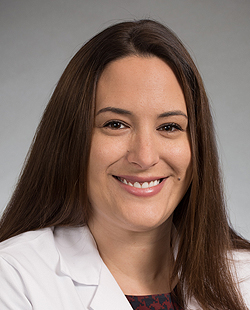 Maralyssa Bann, headshot in white lab coat
