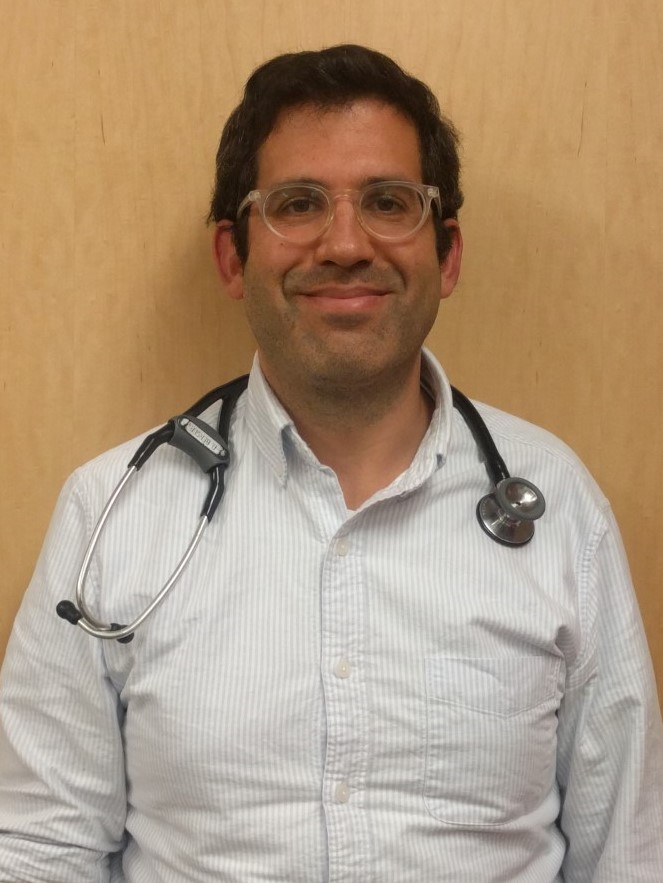 Douglas Berger headshot in a white lab coat